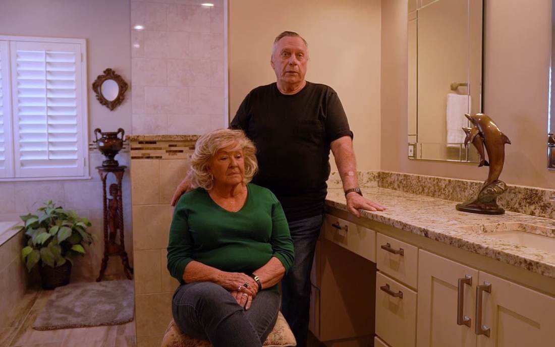 A husband and wife in their finished bathroom remodel by Oklahoma Bath Pros