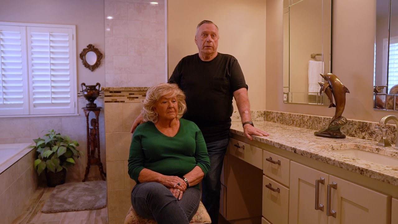 A husband and wife in their finished bathroom remodel by Oklahoma Bath Pros
