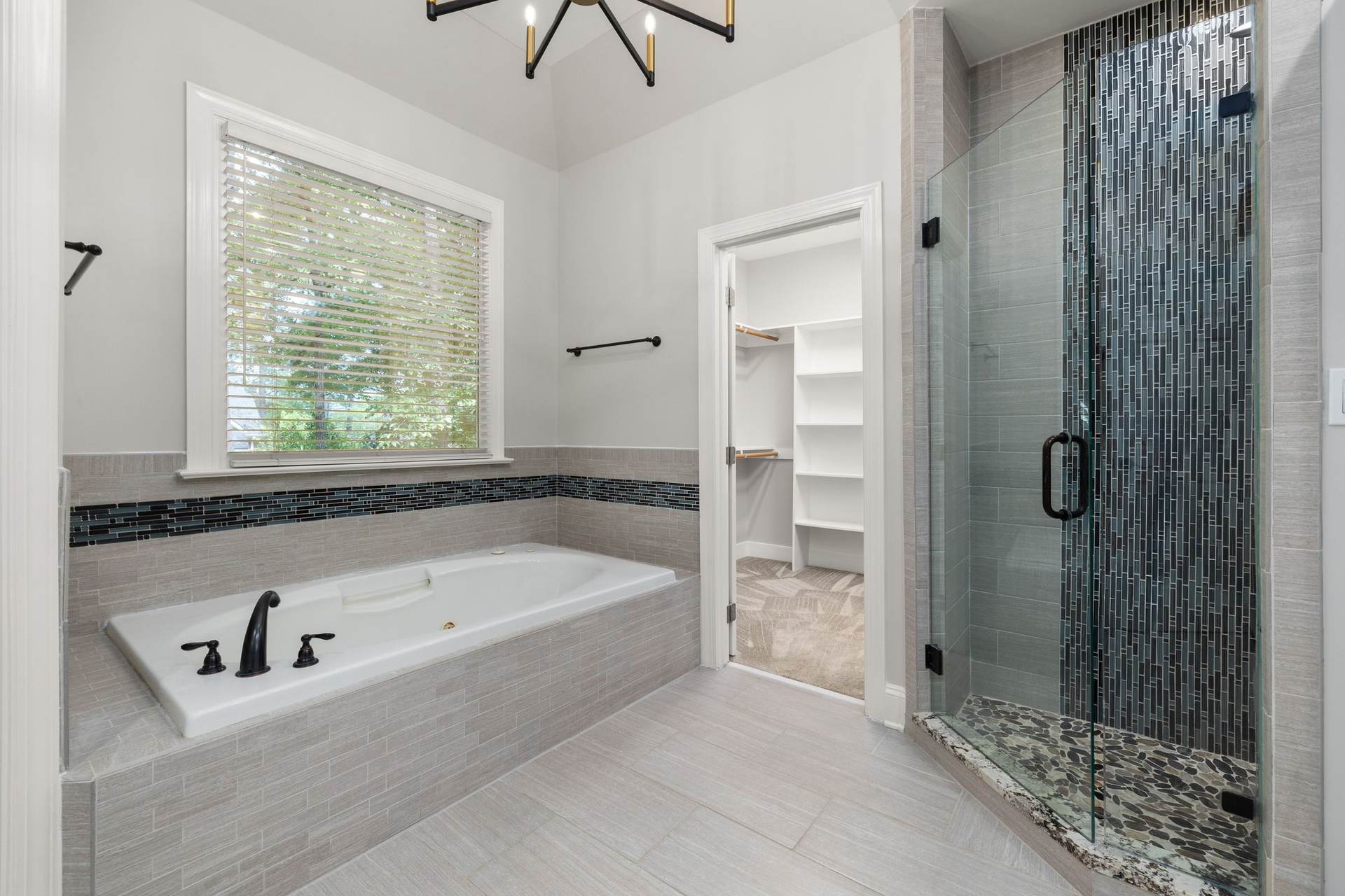 Bathroom remodeling idea: bright bathroom with a frameless glass shower and a tiled soaking tub