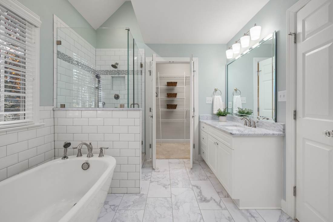 Bathroom remodel idea: white subway tile, a freestanding tub, and a marble-top vanity