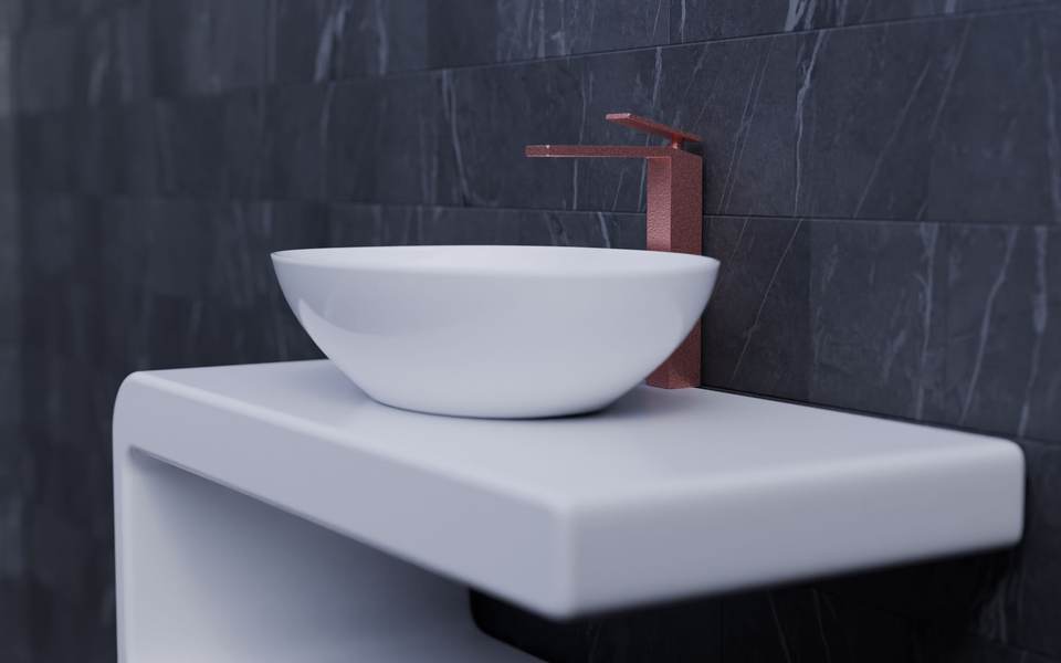 Wall-hung white countertop with a round vessel sink and a copper faucet against dark stone-look tile