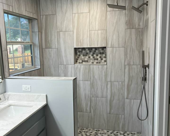 Tiled walk-in shower with a rain head and a hex-tile niche where a jacuzzi garden tub used to be, in a Tulsa master bathroom
