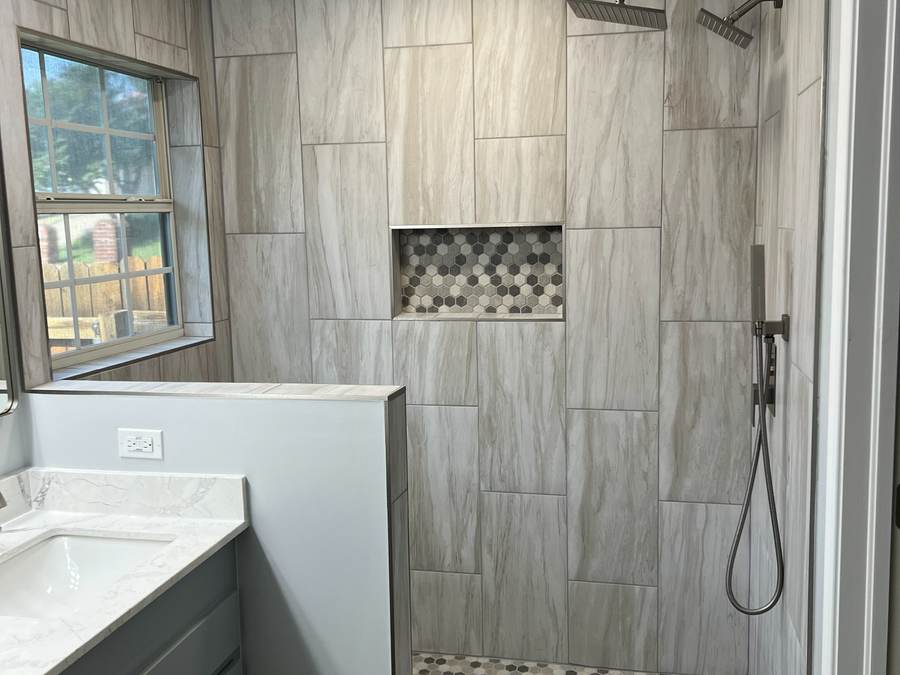 Tiled walk-in shower with a rain head and a hex-tile niche where a jacuzzi garden tub used to be, in a Tulsa master bathroom