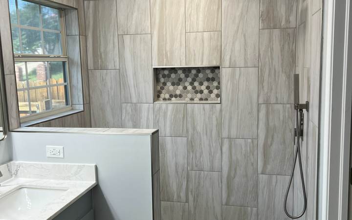 Tiled walk-in shower with a rain head and a hex-tile niche where a jacuzzi garden tub used to be, in a Tulsa master bathroom