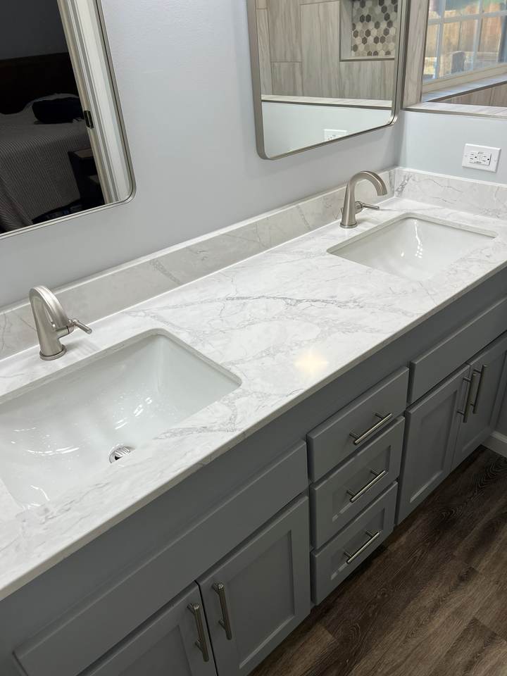 Quartz vanity top with two undermount sinks in the remodeled Tulsa master bathroom