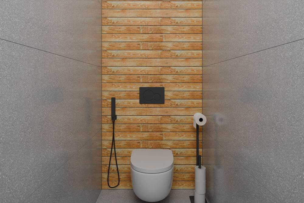 Wall-hung toilet in a narrow room with a wood-look accent wall and a black flush plate